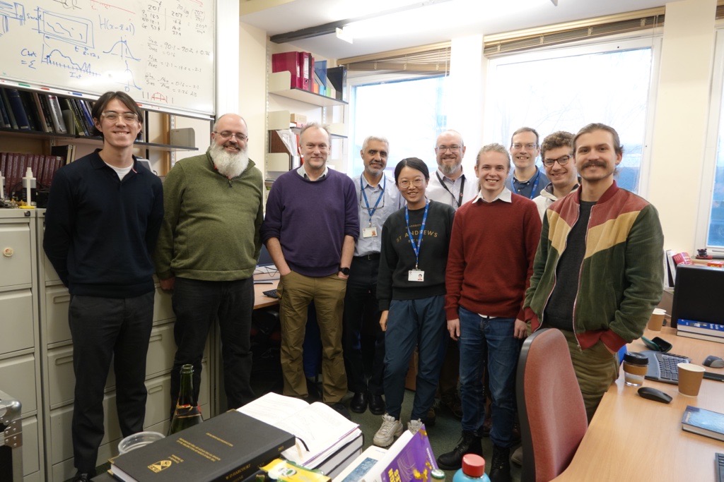 Millimetre Wave Group stood together in the main lab office. 